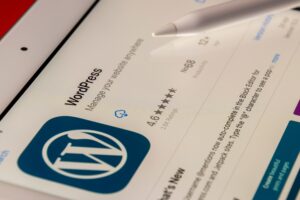 WordPress logo and app in app store, displayed on an electronic tablet.